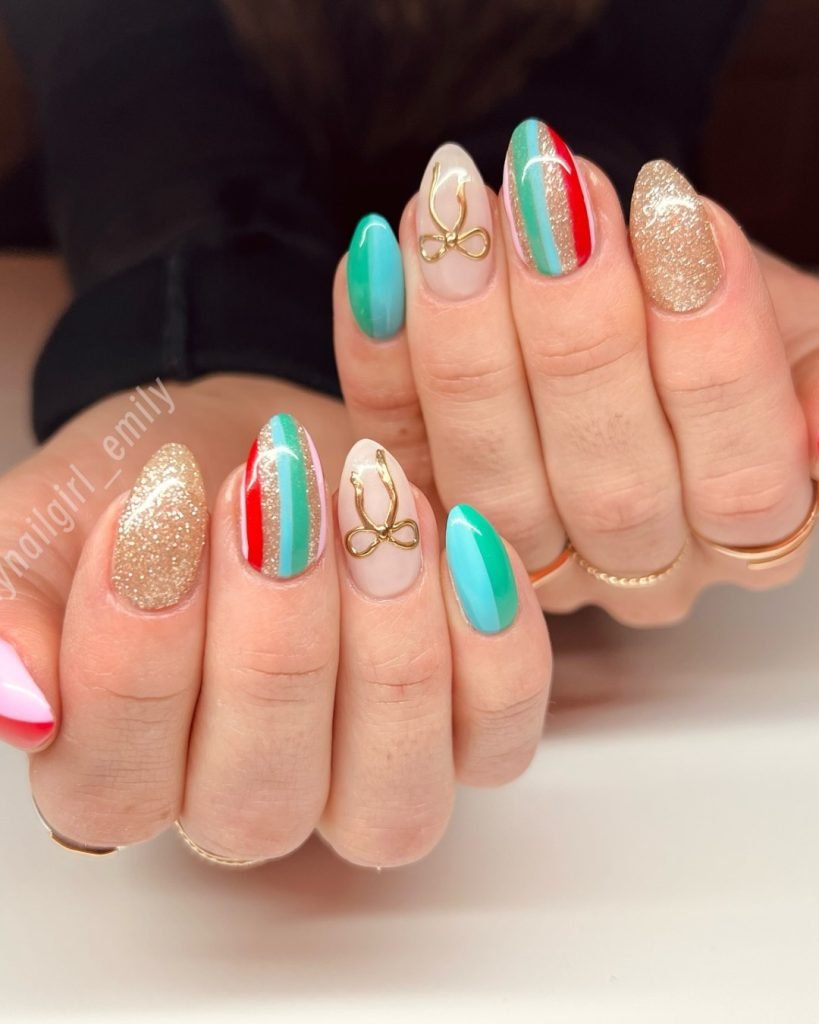 Colorful nail art with gold accents and stripes on manicured hands, featuring teal, red, and glitter designs.