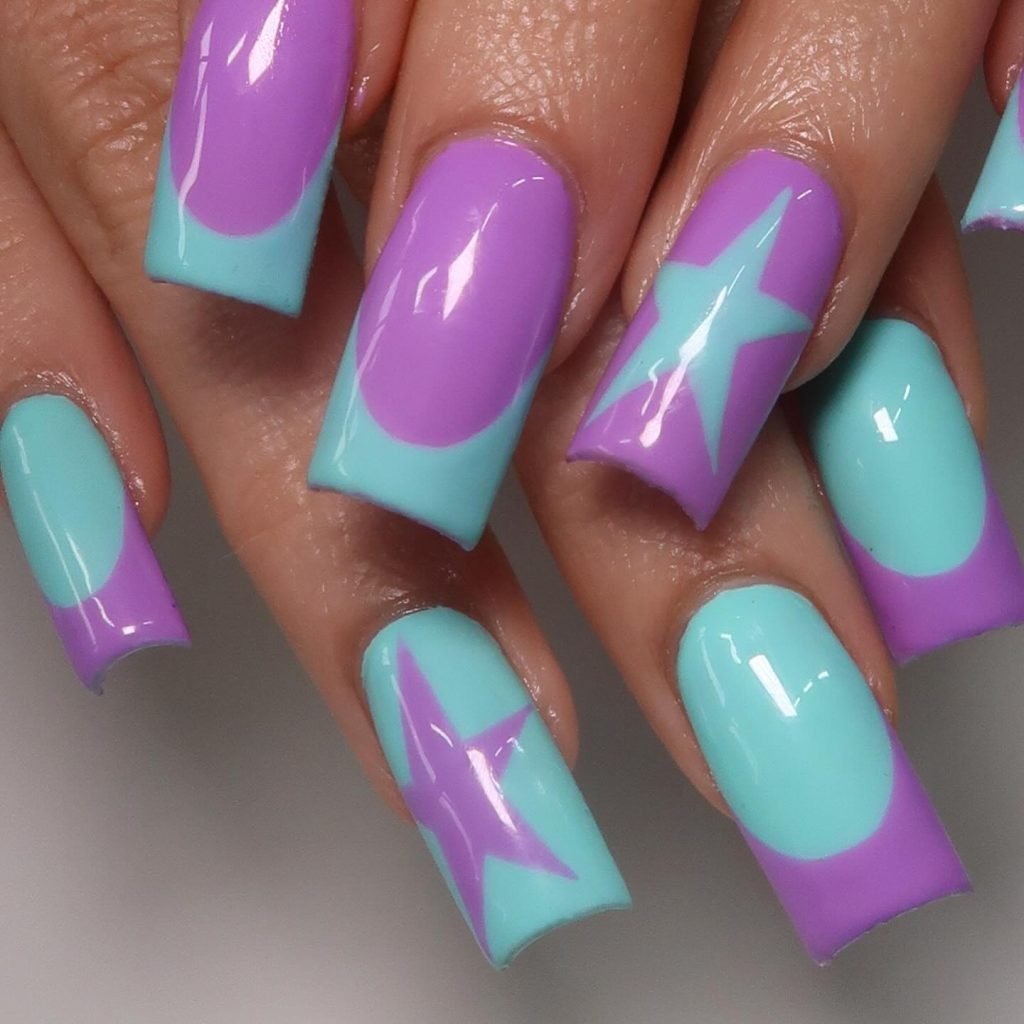 Vibrant purple and turquoise geometric nail art with stars, ovals, and squares on a hand with long square-shaped nails.