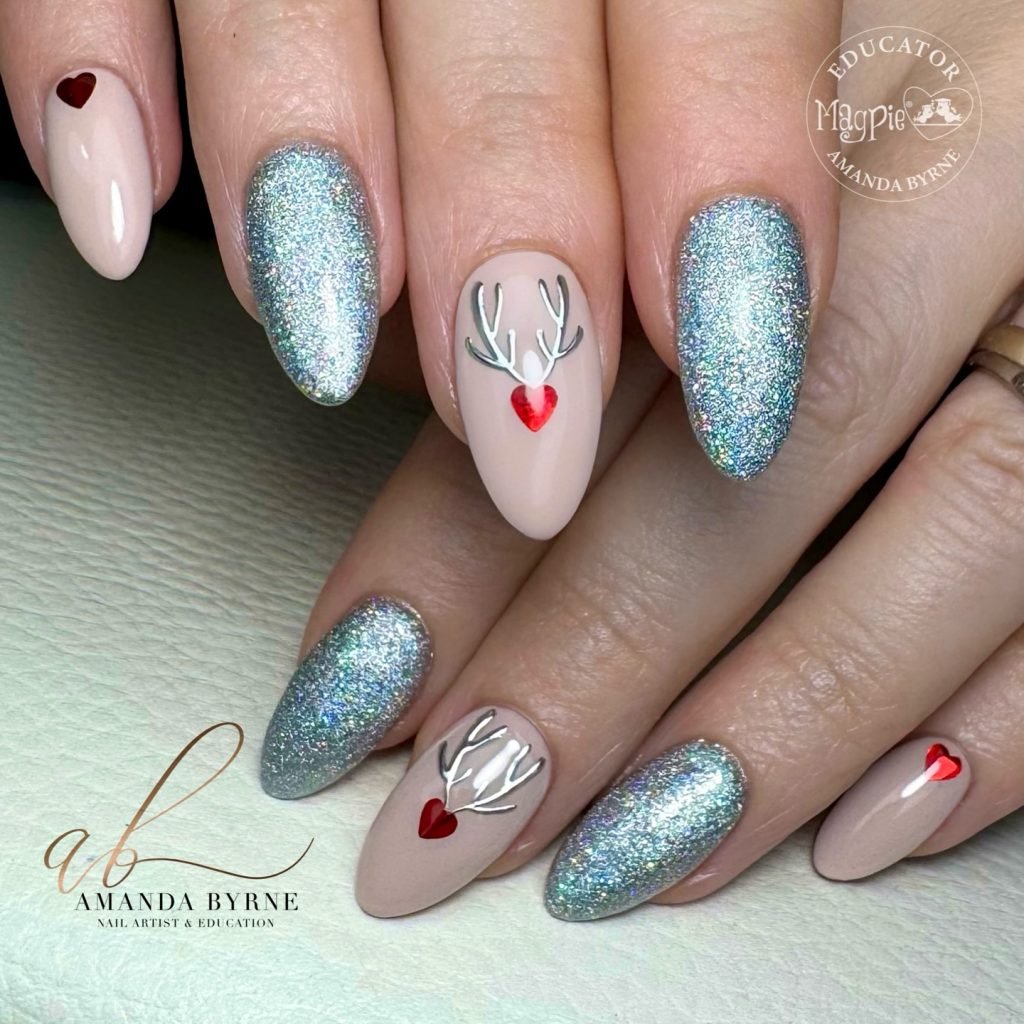 Glittery silver and nude nails with red heart accents and antler nail art design.