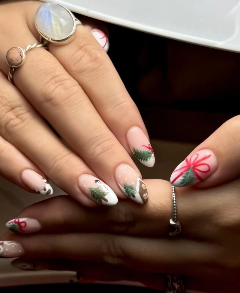 Festive nail art with snowman, Christmas trees, and gifts; holiday manicure with elegant rings on hands.