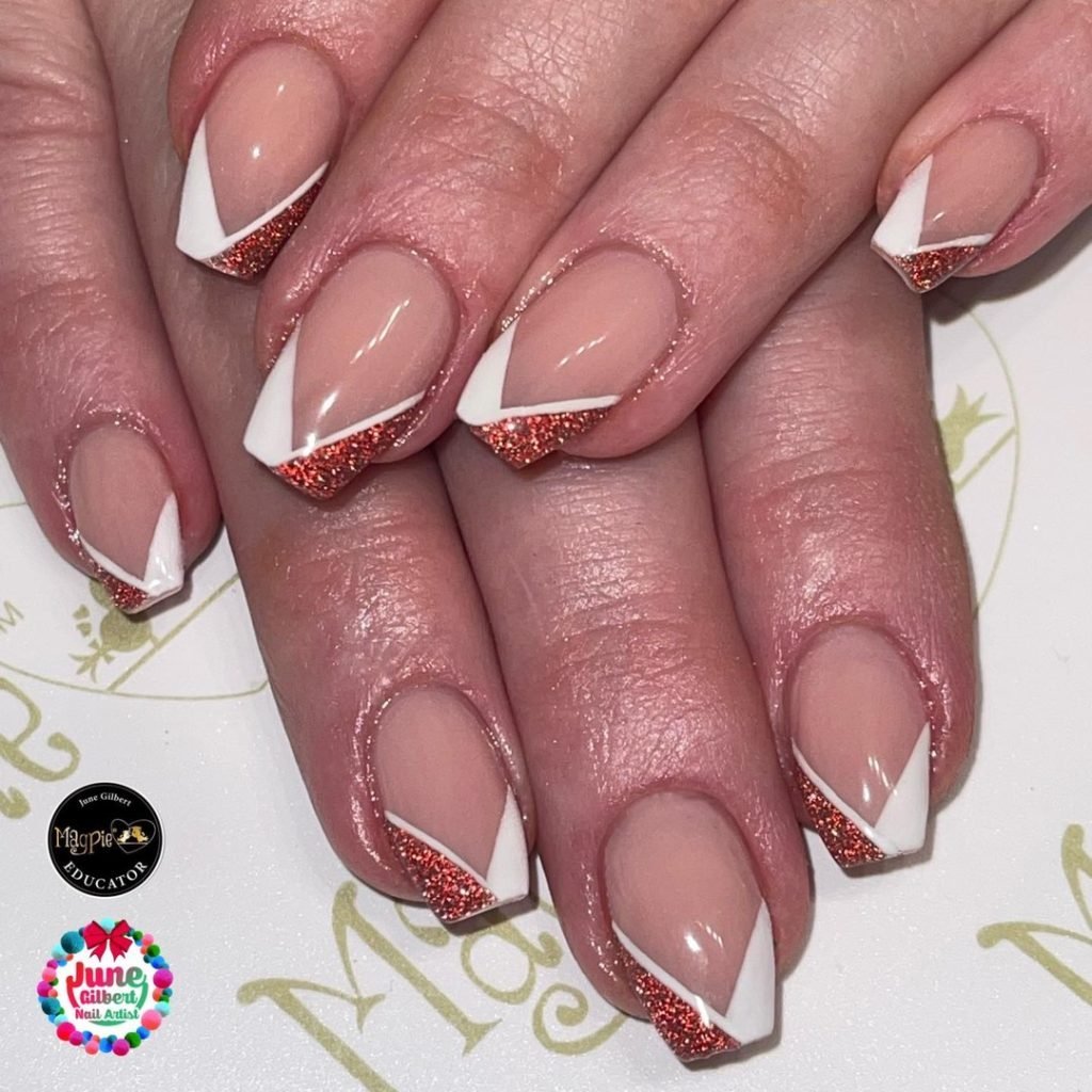 Nails with white and glittery red geometric French tips on a natural base, elegantly styled for a chic manicure look.