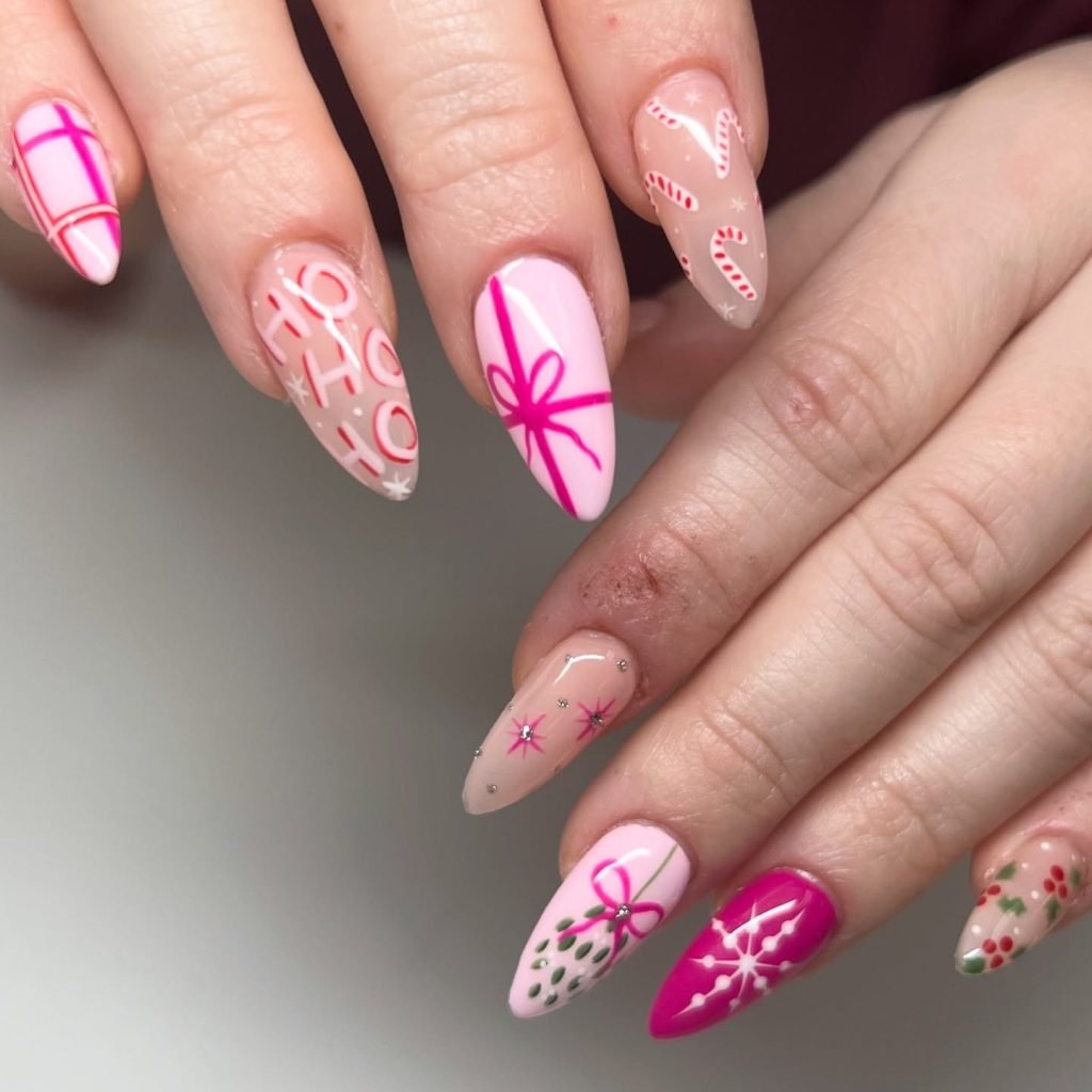 Festive Christmas nail art with candy canes, bows, holly, and snowflakes on almond-shaped nails.