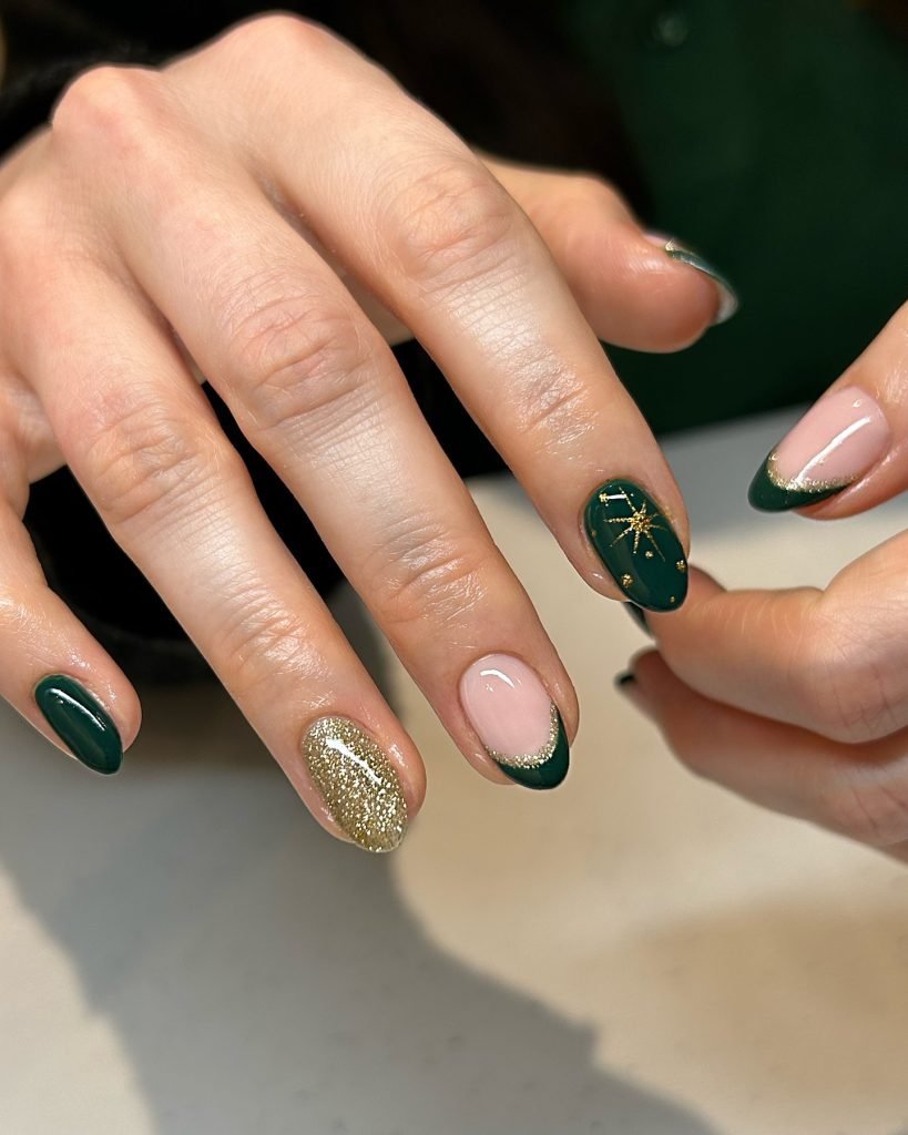 Elegant green and gold festive manicure with star design, close-up on nails.