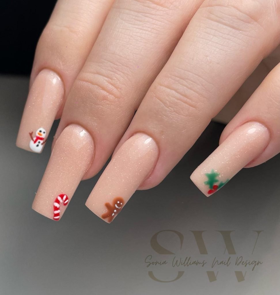 Festive nude nails with Christmas designs: snowman, candy cane, gingerbread man, and holly by Sonia Williams Nail Design.