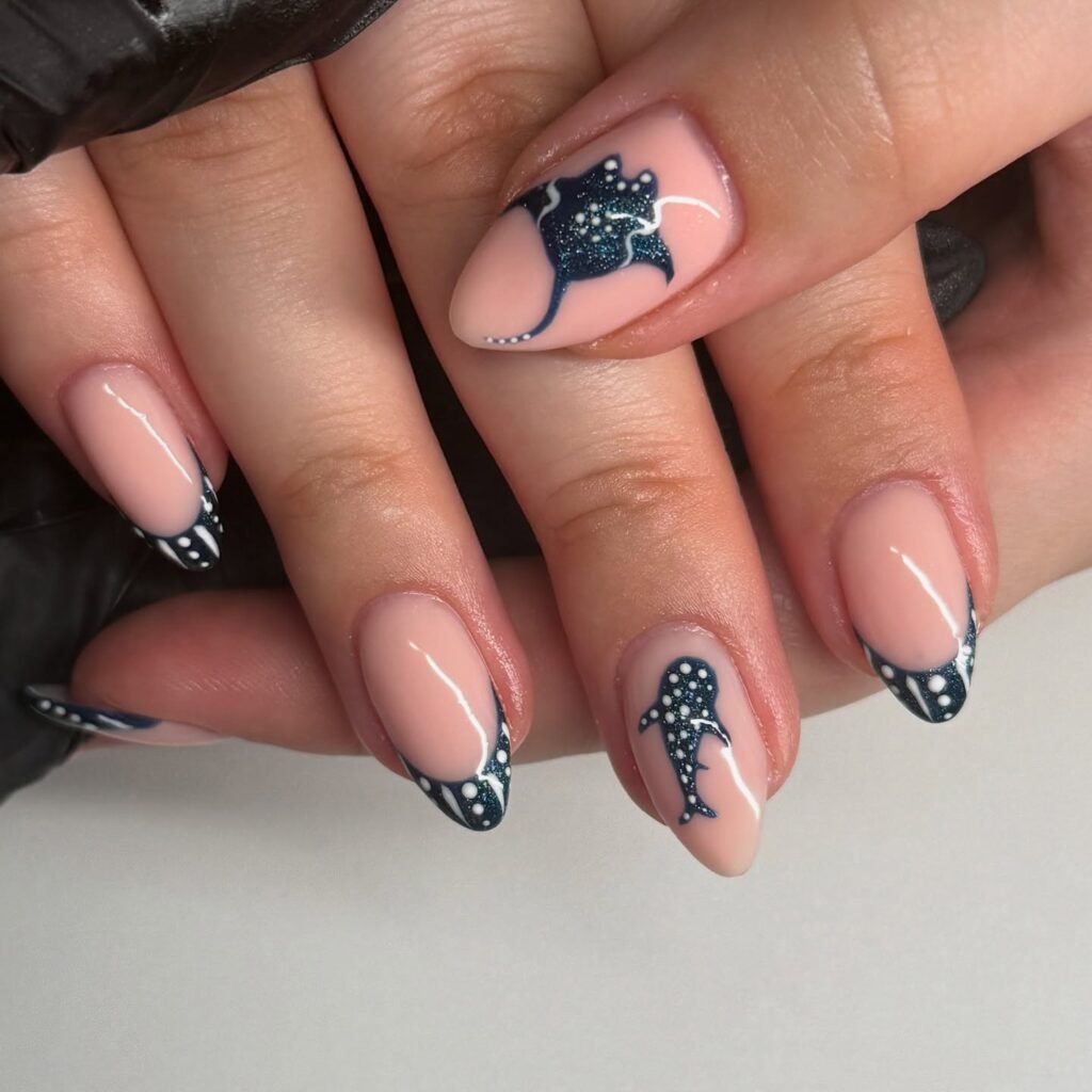 Nude nails with dark blue ocean-themed designs featuring a turtle and shark, detailed with white accents.