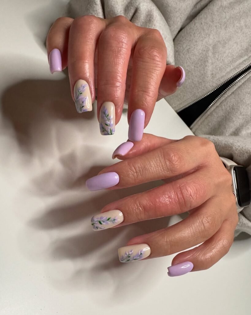Lavender-themed nail art with floral designs on light purple nails, showcasing elegance and style.