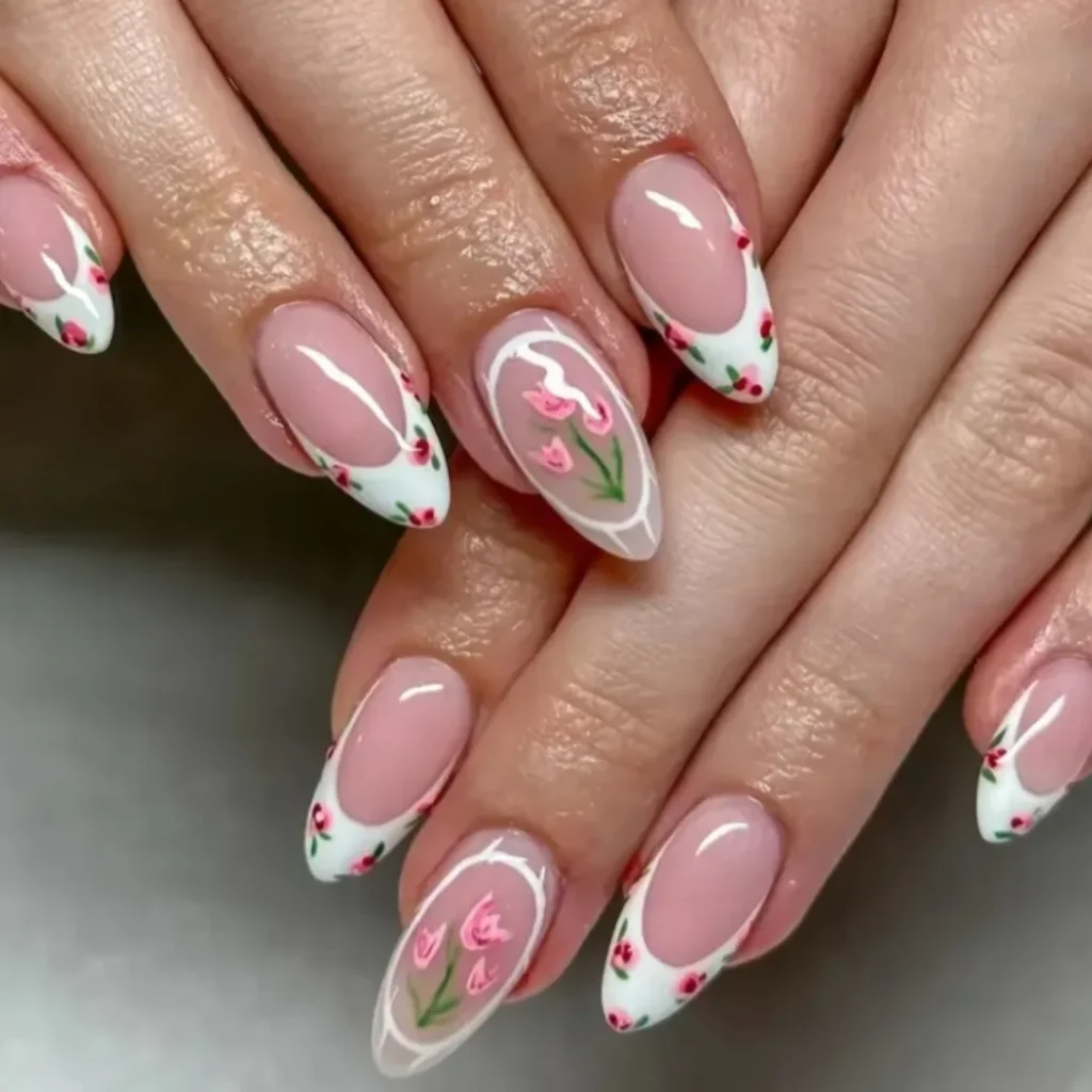 Floral nail art with pink tulip designs on almond-shaped nails with white tips.