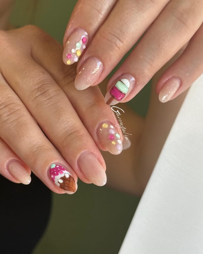 Colorful ice cream-themed nail art with vibrant gel polish and 3D decorations on natural nails.