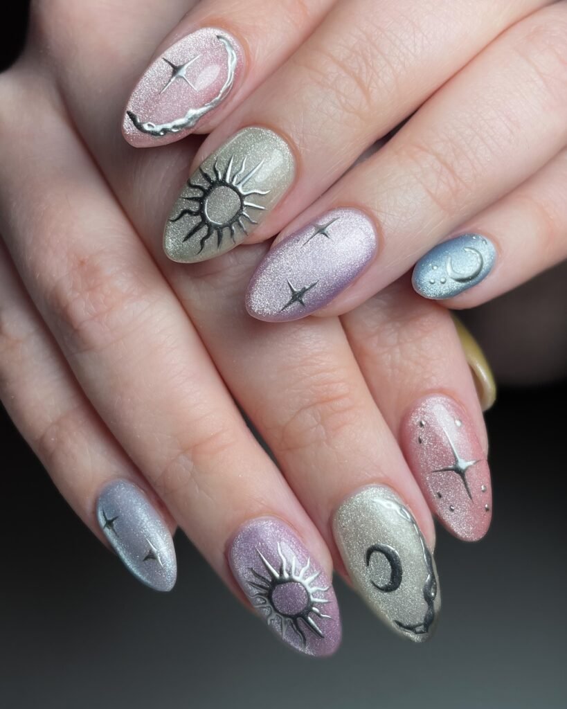 Celestial-themed nail art with sun, moon, and stars design on multi-colored nails.