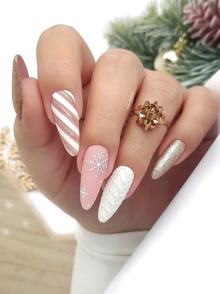 Festive holiday nail art featuring snowflakes, candy cane stripes, knit texture, and gold glitter for a winter theme.