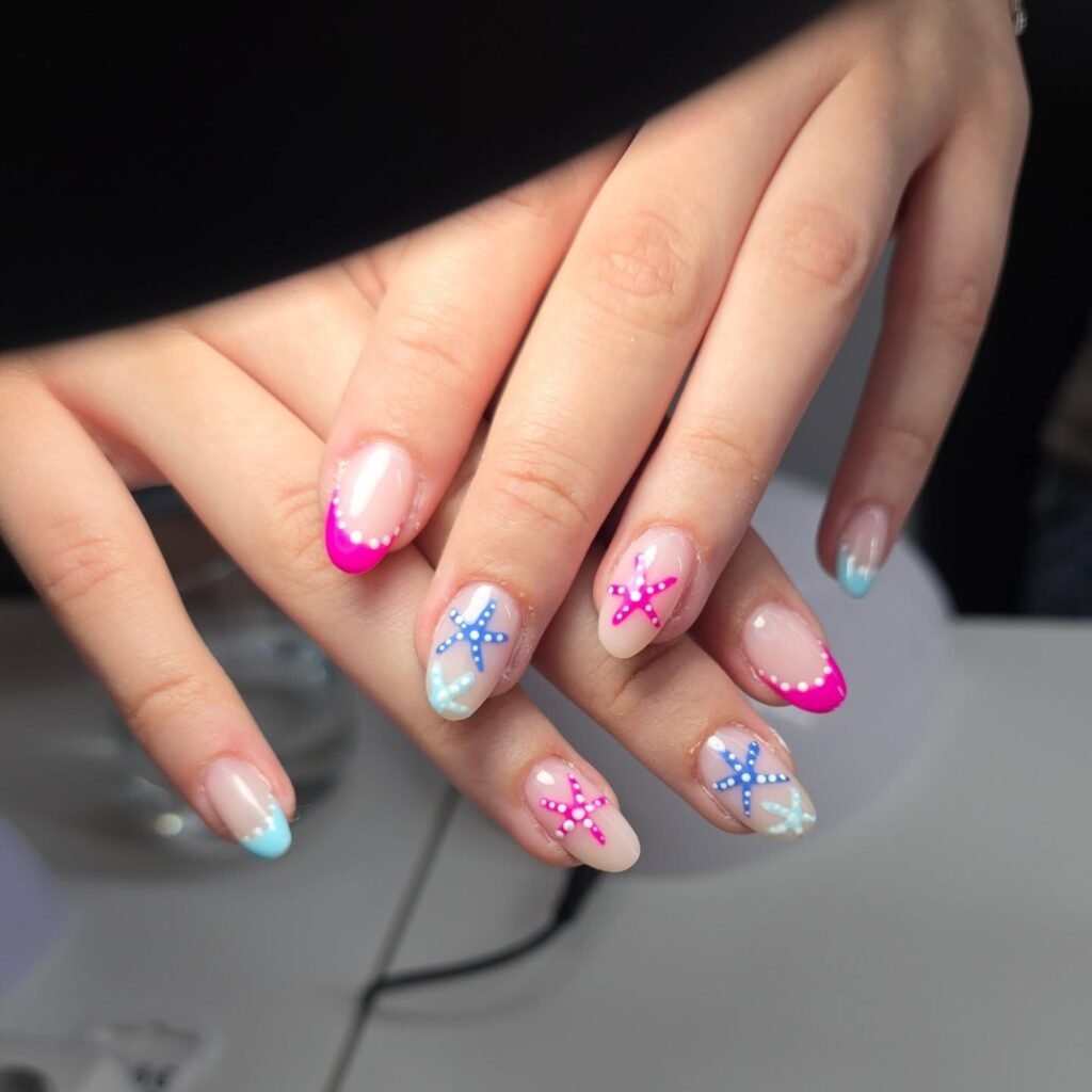 Colorful nails with starfish designs and vibrant French tips.