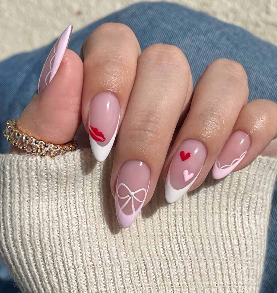 Elegant nail art with red lips, hearts, and bows on almond-shaped nails, perfect for a romantic look.