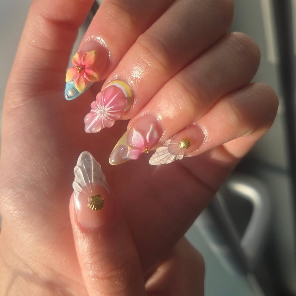 Floral 3D nail art with vibrant blossoms and transparent tips, perfect for a trendy and colorful manicure style.