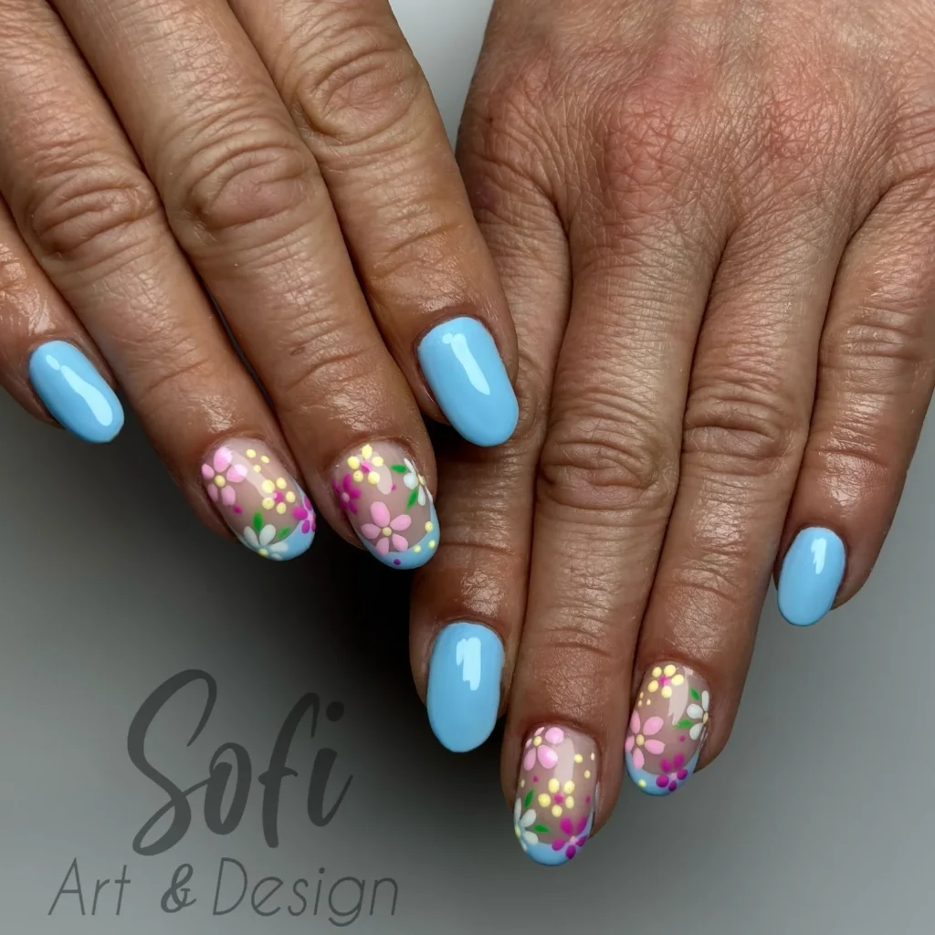 Aesthetic blue floral nail art design with pastel flower patterns by Sofi Art & Design.