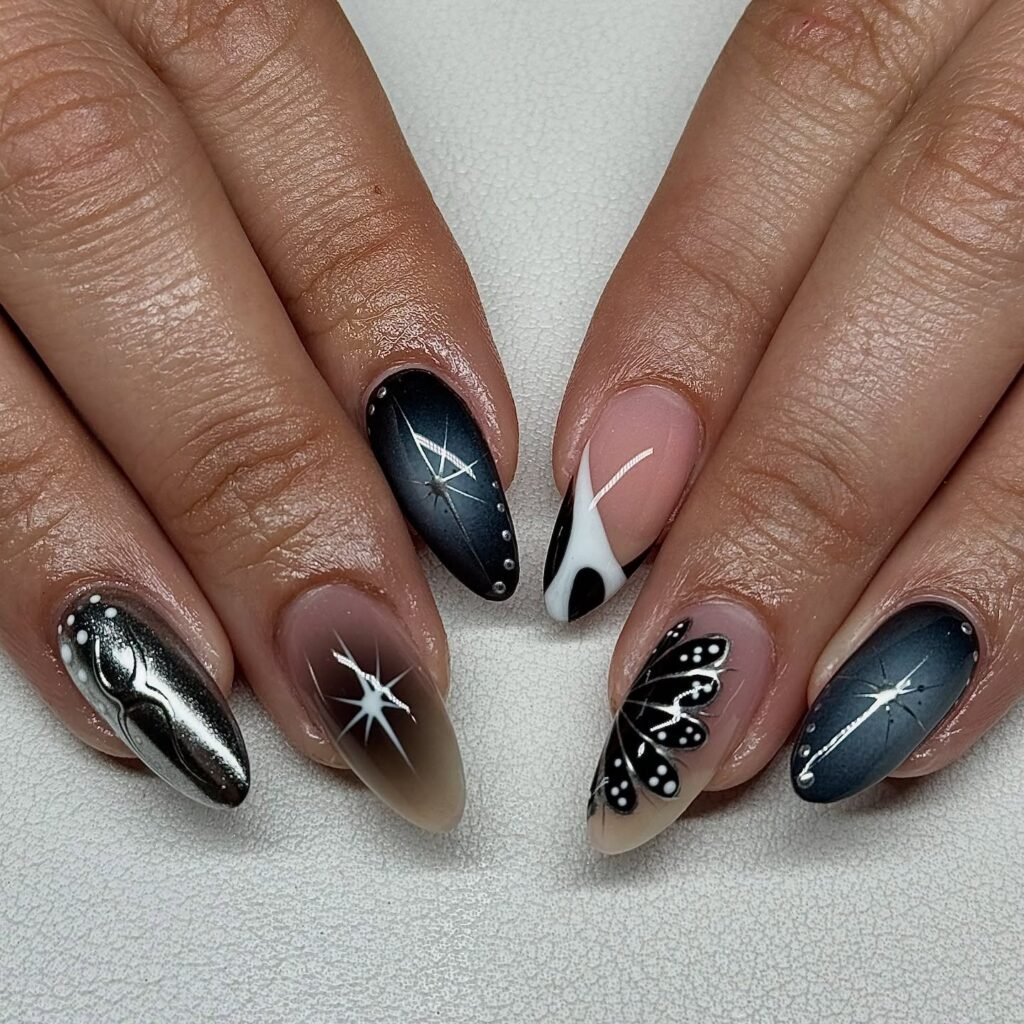Elegant black and white butterfly nail art with starry designs on manicured hands.