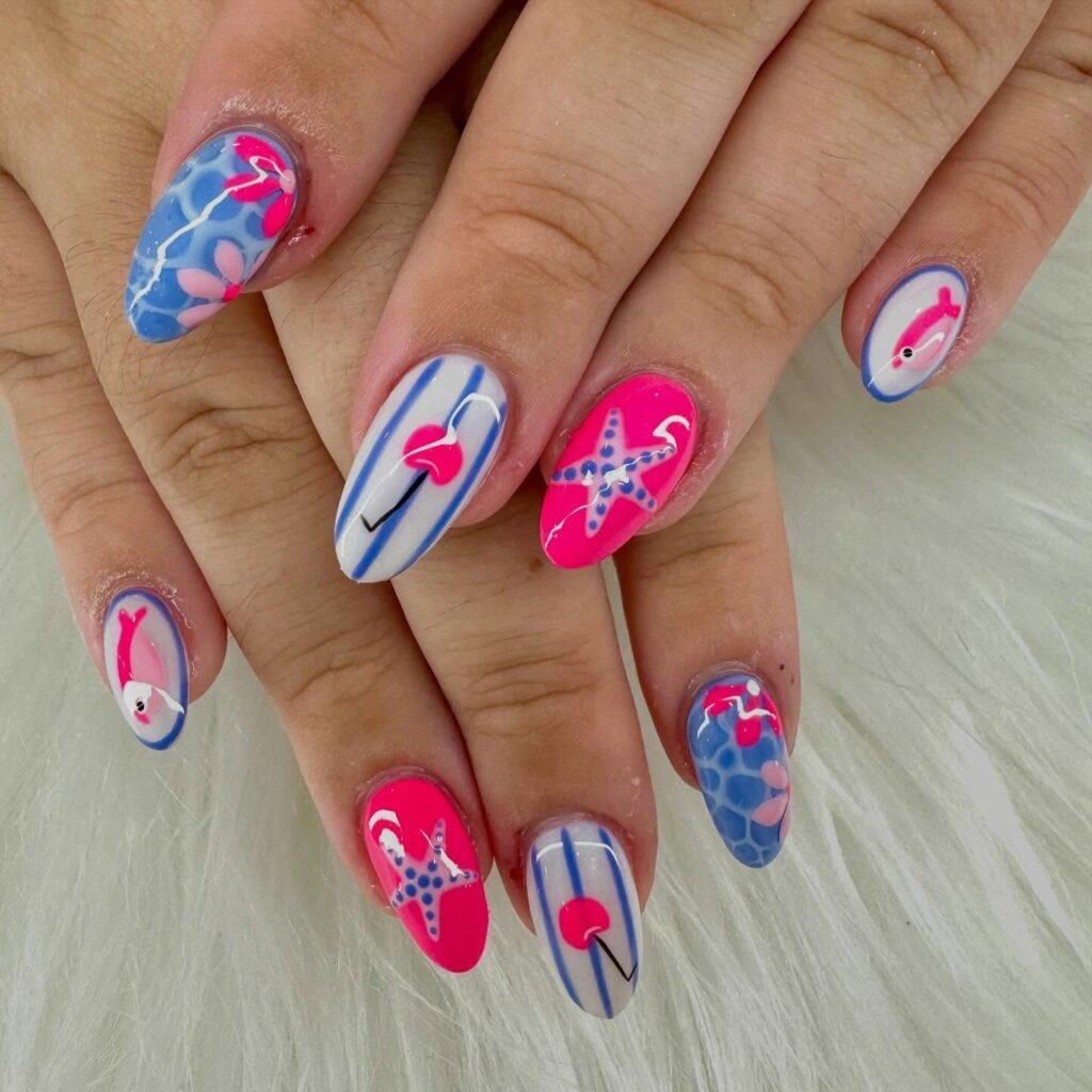 Colorful summer-themed nail art featuring flamingos, starfish, and stripes on manicured nails.