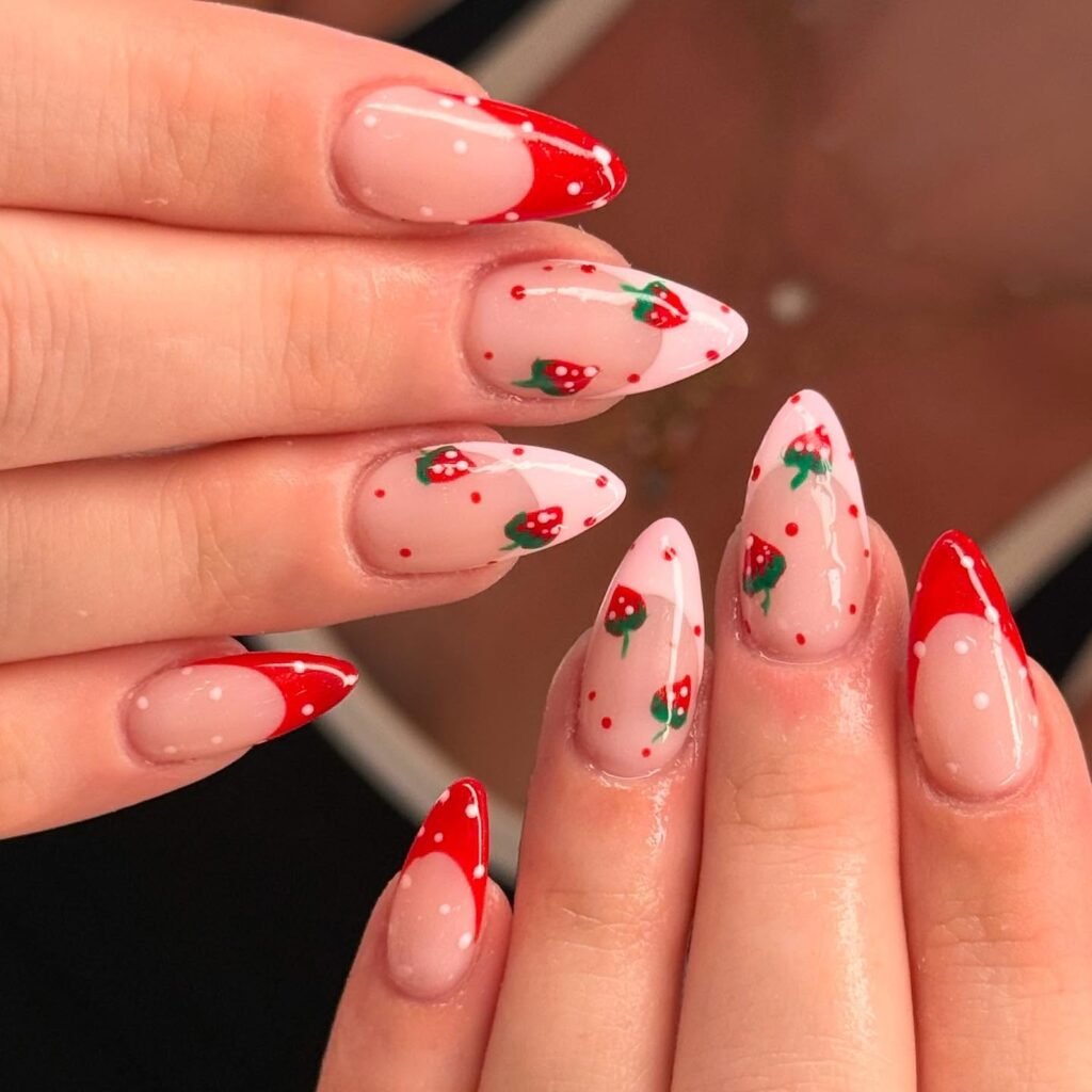 Red strawberry nail art on almond-shaped nails with a glossy finish.
