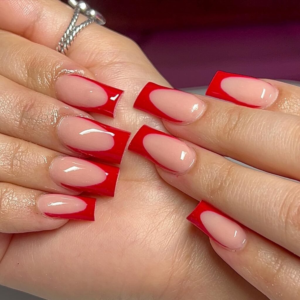 Red French tip coffin nails with glossy finish for a chic and elegant manicure style.