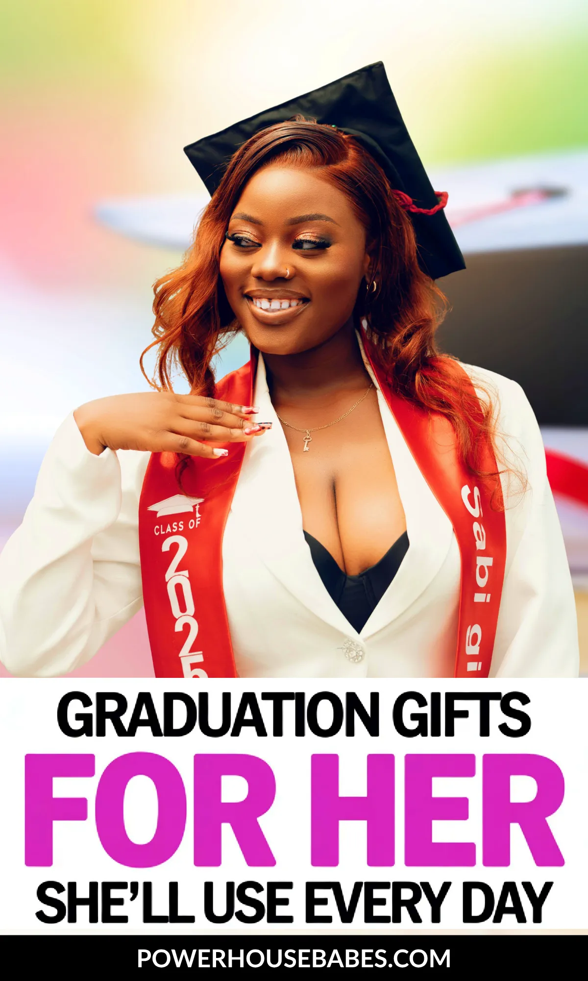Smiling graduate in cap and gown showcasing stylish graduation gifts for women she'll use daily.